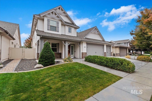 craftsman-style home with a front yard and a garage