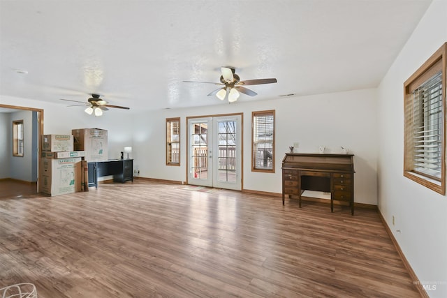 living room with ceiling fan, french doors, and dark wood-type flooring