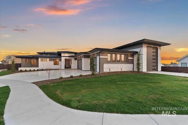 9891 W Napier Ct, Star, ID 83669 - prairie-style home featuring a garage, a yard, concrete driveway, and fence