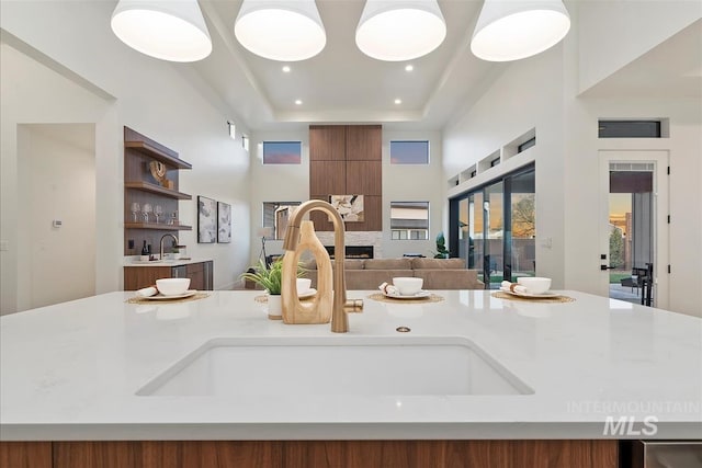 9891 W Napier Ct, Star, ID 83669 - kitchen with a towering ceiling, open shelves, a sink, light countertops, and recessed lighting