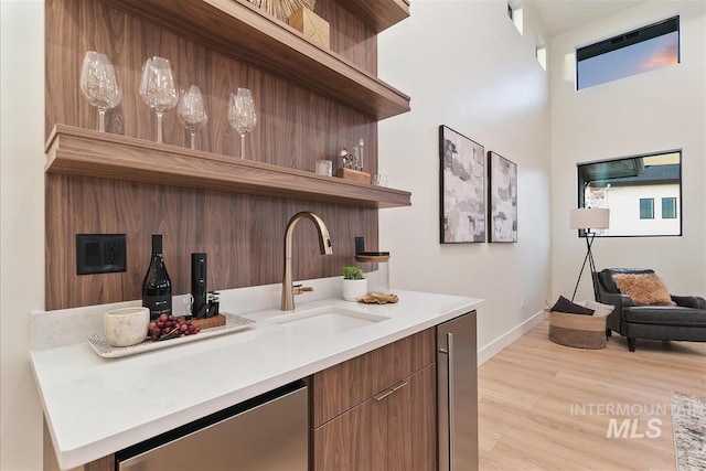 9891 W Napier Ct, Star, ID 83669 - bar with a sink, baseboards, stainless steel dishwasher, and light wood-type flooring