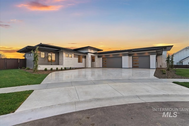 9891 W Napier Ct, Star, ID 83669 - prairie-style home with a lawn, a garage, fence, and concrete driveway