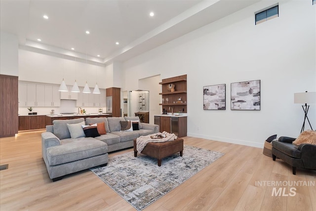 9891 W Napier Ct, Star, ID 83669 - living room with light wood-type flooring, recessed lighting, baseboards, and a high ceiling