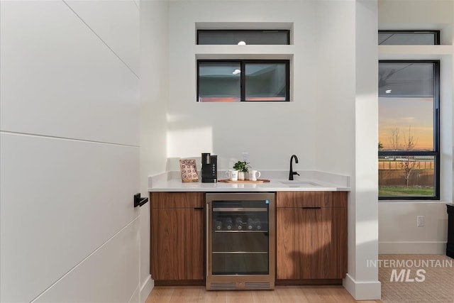 9891 W Napier Ct, Star, ID 83669 - bar with baseboards, wet bar, a sink, and wine cooler
