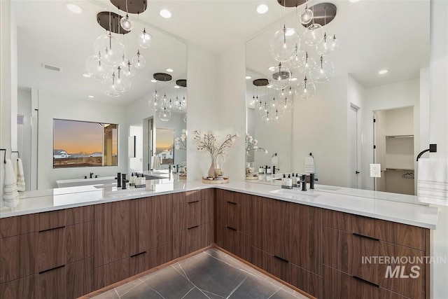 9891 W Napier Ct, Star, ID 83669 - bathroom featuring visible vents, double vanity, recessed lighting, tile patterned floors, and a sink