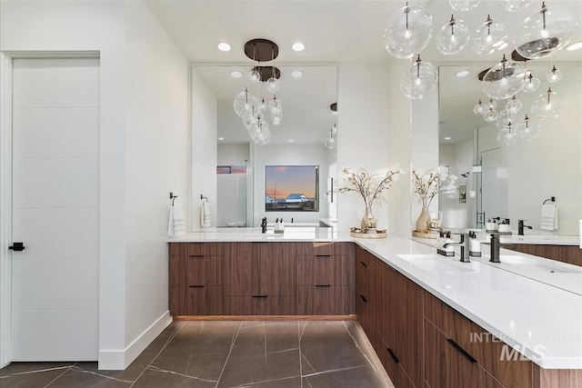 9891 W Napier Ct, Star, ID 83669 - bathroom featuring baseboards, a sink, two vanities, and recessed lighting