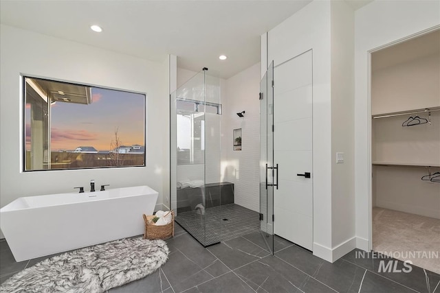 9891 W Napier Ct, Star, ID 83669 - full bath with a walk in closet, a freestanding tub, tile patterned flooring, a shower stall, and recessed lighting