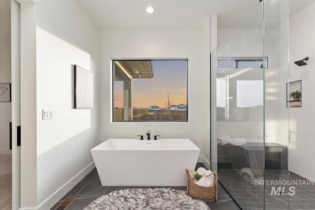 9891 W Napier Ct, Star, ID 83669 - full bath with a freestanding tub, tile patterned flooring, baseboards, and a shower stall