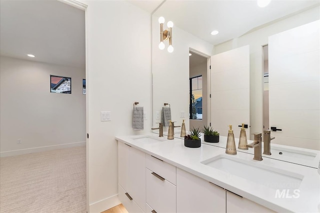 9891 W Napier Ct, Star, ID 83669 - bathroom featuring double vanity, baseboards, recessed lighting, and a sink