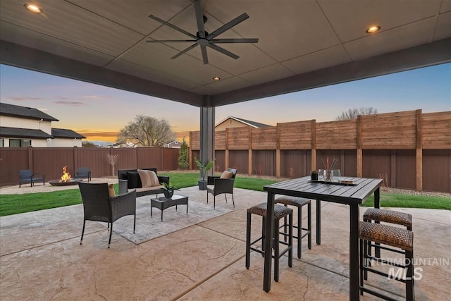 9891 W Napier Ct, Star, ID 83669 - view of patio / terrace featuring ceiling fan, a fenced backyard, outdoor dining space, and an outdoor living space with a fire pit