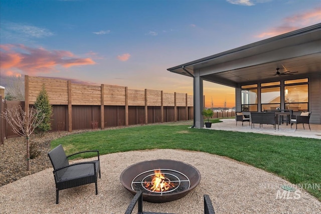 9891 W Napier Ct, Star, ID 83669 - yard at dusk with a patio, a ceiling fan, a fire pit, and a fenced backyard