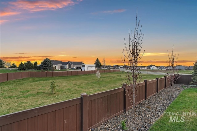 9891 W Napier Ct, Star, ID 83669 - yard at dusk with a fenced backyard and a residential view