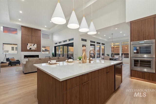 9891 W Napier Ct, Star, ID 83669 - kitchen with appliances with stainless steel finishes, a sink, a towering ceiling, and modern cabinets