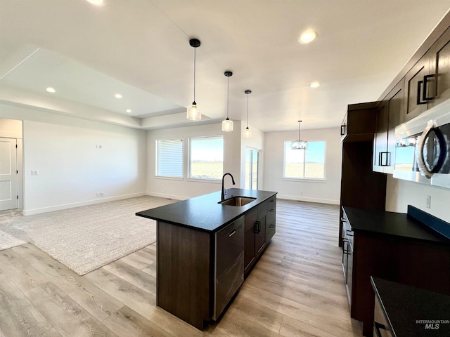 kitchen featuring dark countertops, a sink, and dark brown cabinets