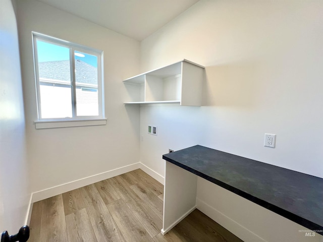 clothes washing area with light wood-type flooring, laundry area, washer hookup, and baseboards