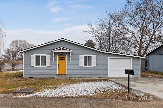 view of front of property featuring concrete driveway and an attached garage