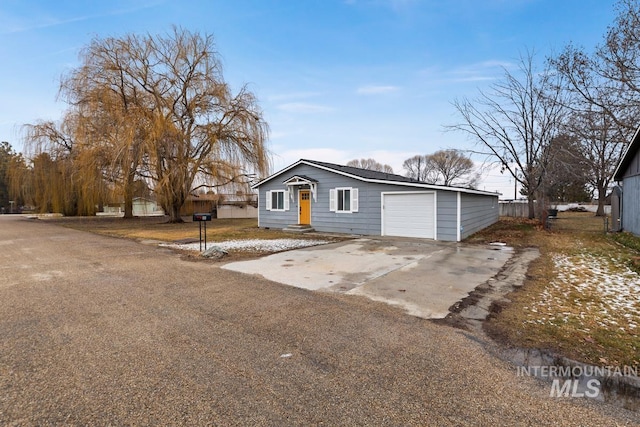 view of front facade with concrete driveway and an attached garage