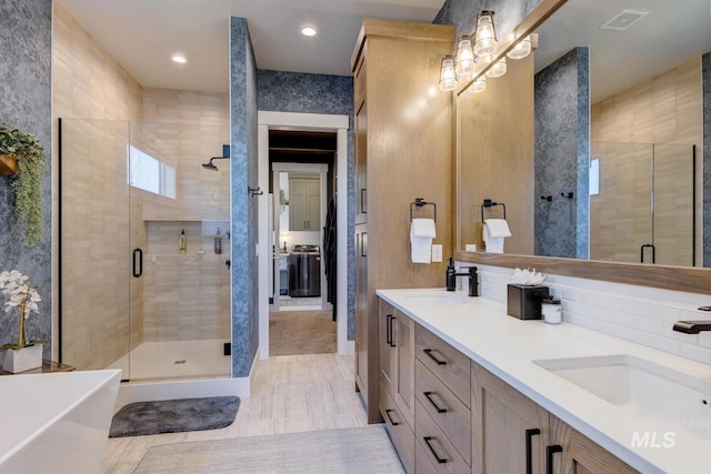full bath featuring visible vents, a sink, and a stall shower