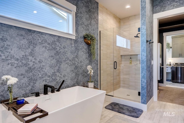 full bathroom featuring a shower stall, recessed lighting, and a soaking tub