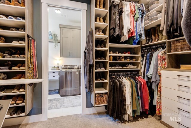 spacious closet with washer / clothes dryer and carpet floors