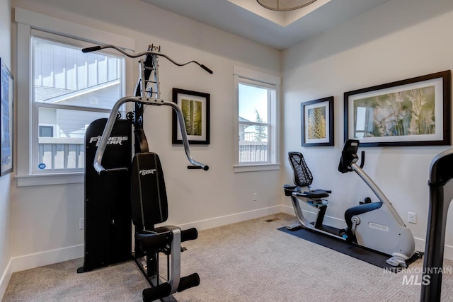 exercise room with carpet flooring and baseboards