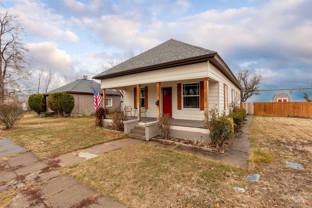 view of front of home with a porch and a front lawn