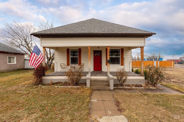 bungalow featuring a front yard and covered porch