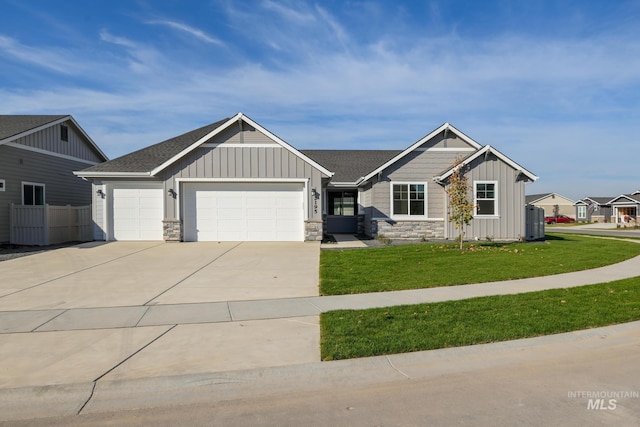 craftsman-style house featuring a front lawn, stone siding, board and batten siding, concrete driveway, and a garage