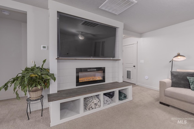 carpeted living room featuring a fireplace