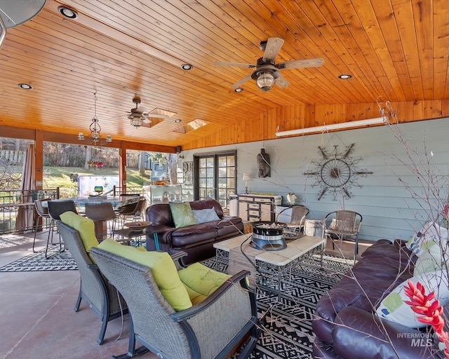 view of patio featuring ceiling fan, outdoor dining area, and an outdoor living space with a fire pit