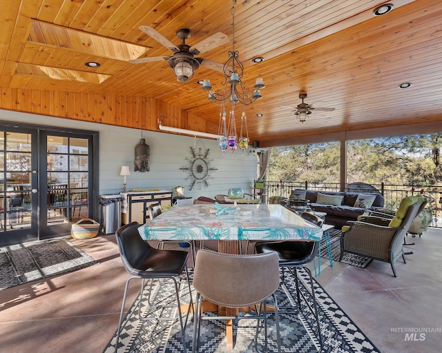 sunroom featuring wood ceiling, ceiling fan, and french doors