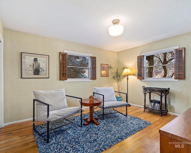 living area featuring wood finished floors and baseboards