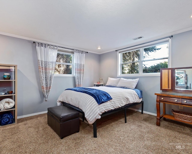 bedroom with carpet floors, baseboards, visible vents, and ornamental molding