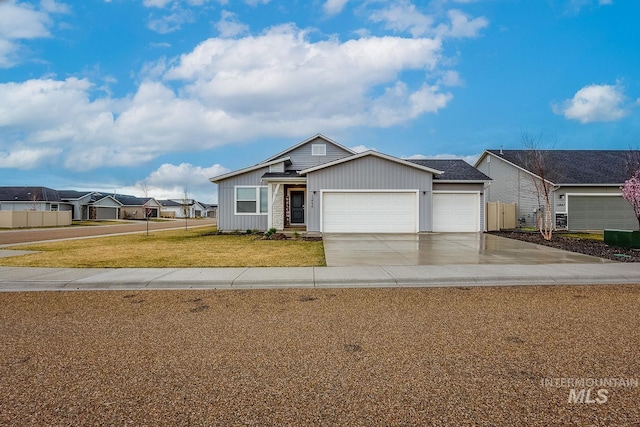 view of front facade with fence, a garage, a front yard, board and batten siding, and driveway