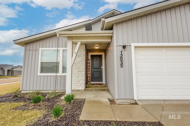 entrance to property featuring board and batten siding and a garage
