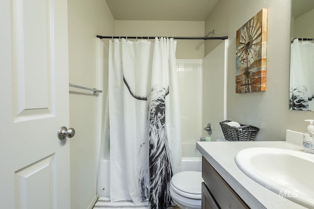 bathroom featuring toilet, shower / tub combo, and vanity