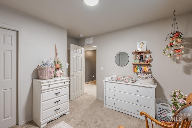 bedroom featuring visible vents and light colored carpet