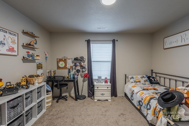 bedroom featuring light carpet, baseboards, visible vents, and a textured ceiling