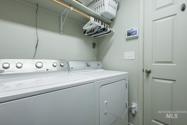 clothes washing area featuring independent washer and dryer and laundry area