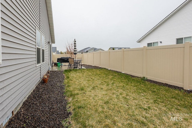 view of yard with a patio and a fenced backyard