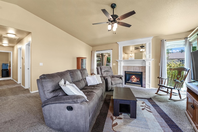 13725 W Fig St, Boise, ID 83713 - carpeted living room with a ceiling fan, lofted ceiling, a tile fireplace, and baseboards
