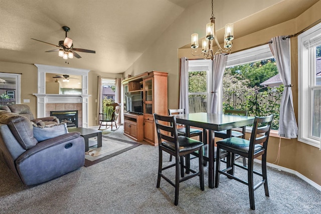 13725 W Fig St, Boise, ID 83713 - dining area with carpet floors, plenty of natural light, a tiled fireplace, and lofted ceiling