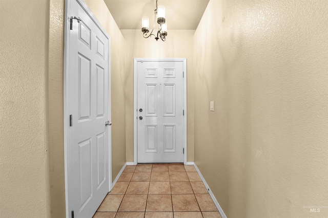 13725 W Fig St, Boise, ID 83713 - doorway to outside featuring light tile patterned floors, a chandelier, and baseboards