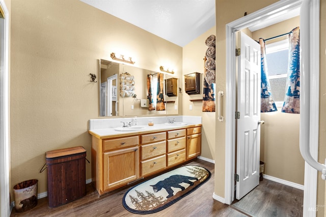 13725 W Fig St, Boise, ID 83713 - bathroom with wood finished floors, double vanity, baseboards, and lofted ceiling