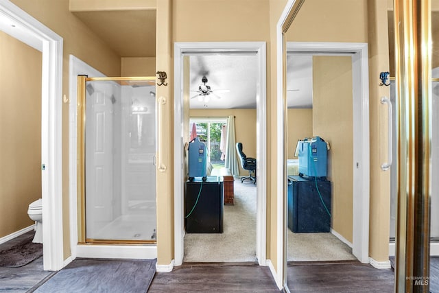 13725 W Fig St, Boise, ID 83713 - full bath with a shower stall, wood finished floors, toilet, a ceiling fan, and baseboards