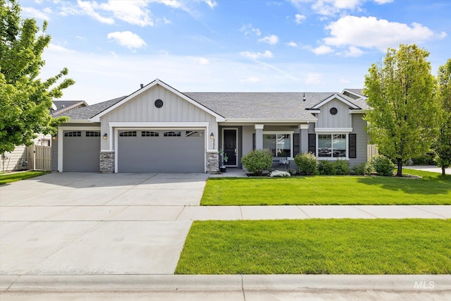 view of front of property with board and batten siding, a garage, driveway, and a front yard