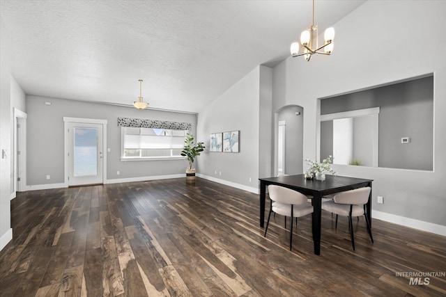 dining area featuring hardwood / wood-style floors, arched walkways, lofted ceiling, baseboards, and a chandelier