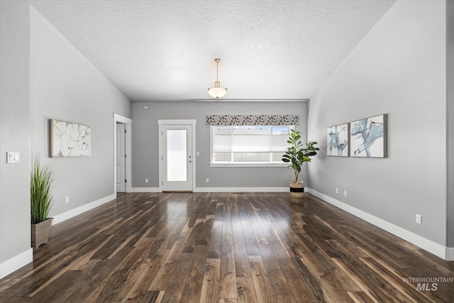 foyer featuring hardwood / wood-style floors, a textured ceiling, and baseboards