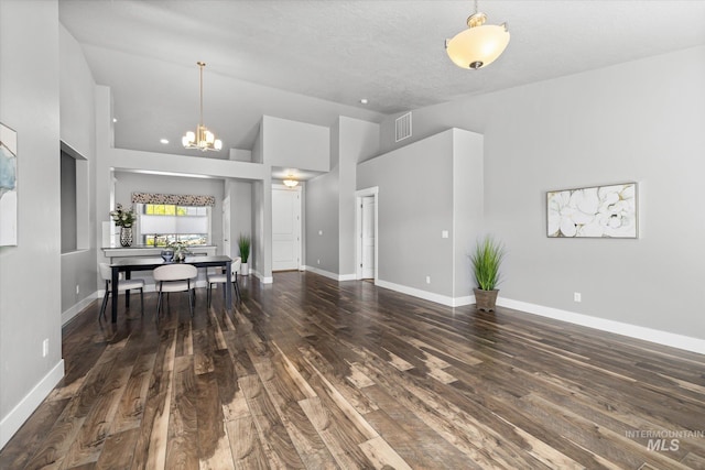 living area featuring wood finished floors, a chandelier, baseboards, and high vaulted ceiling