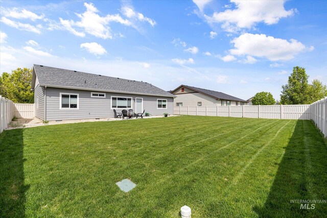 rear view of property with a patio and roof with shingles